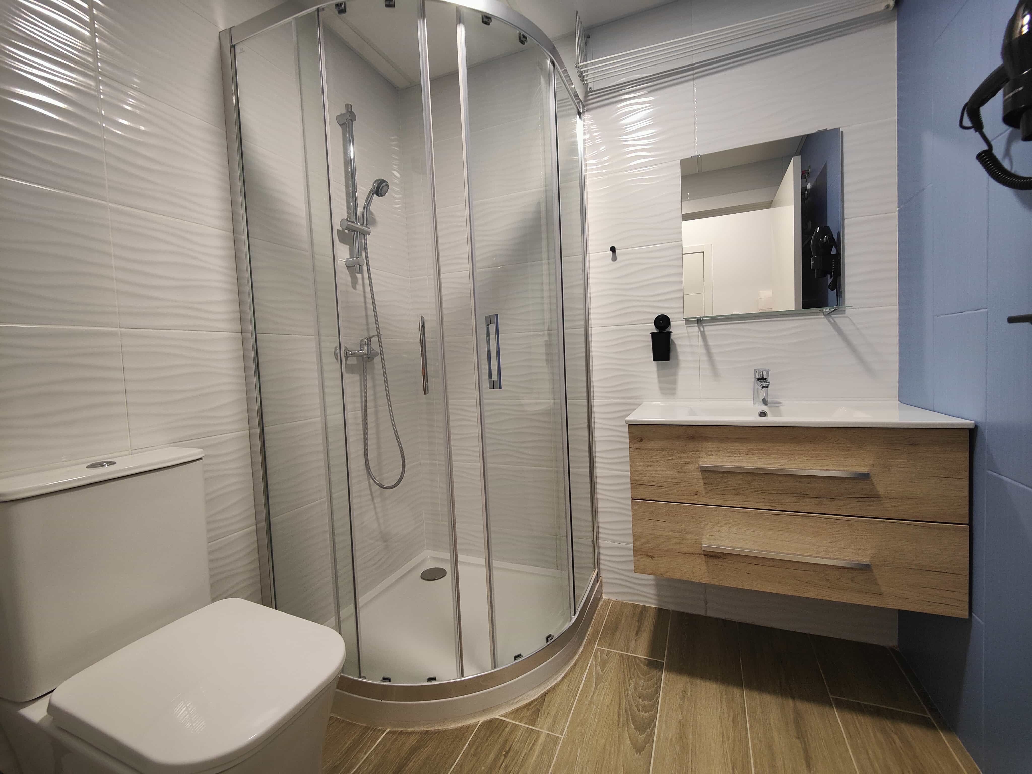 Modern bathroom with walk-in shower inside Apartamentos Pueblo Mar