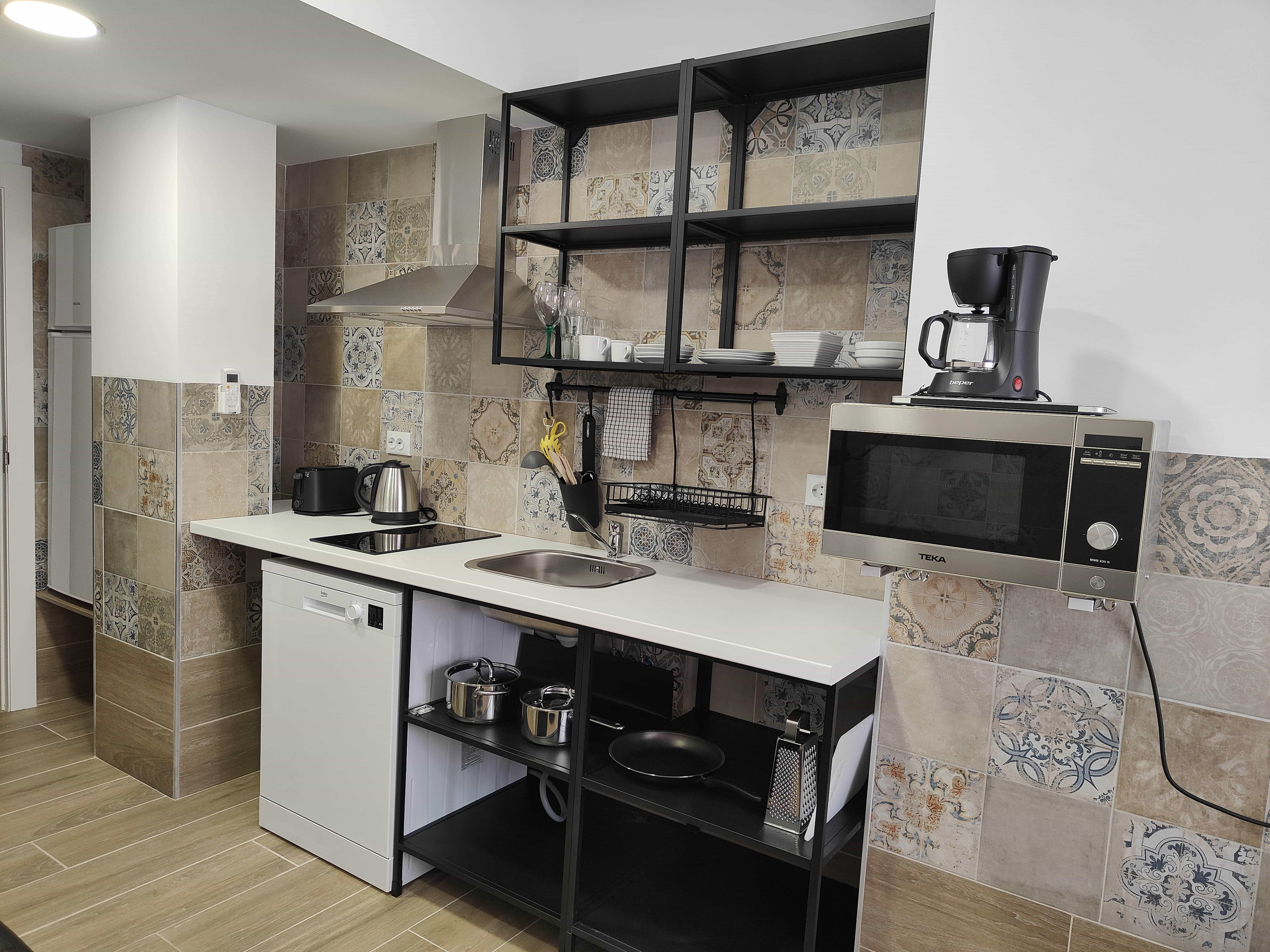 Fully equipped kitchen space inside Apartamentos Pueblo Mar