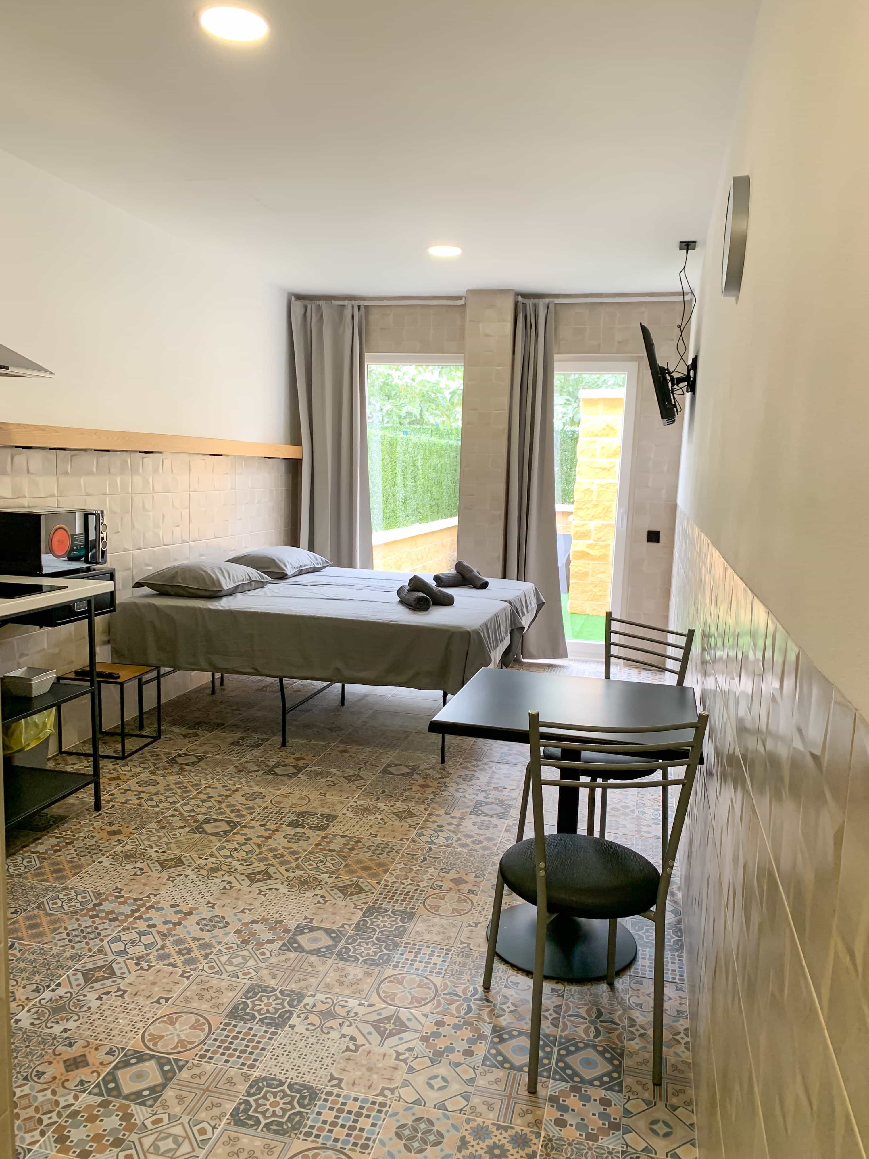 Studio apartment interior with bed and sofa at Apartamentos La Ruta